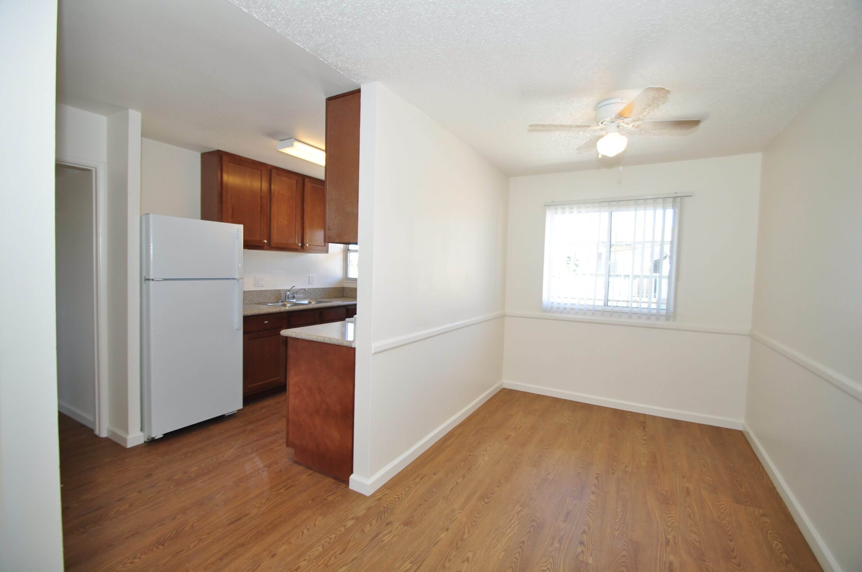 Empty apartment dining area with kitchen